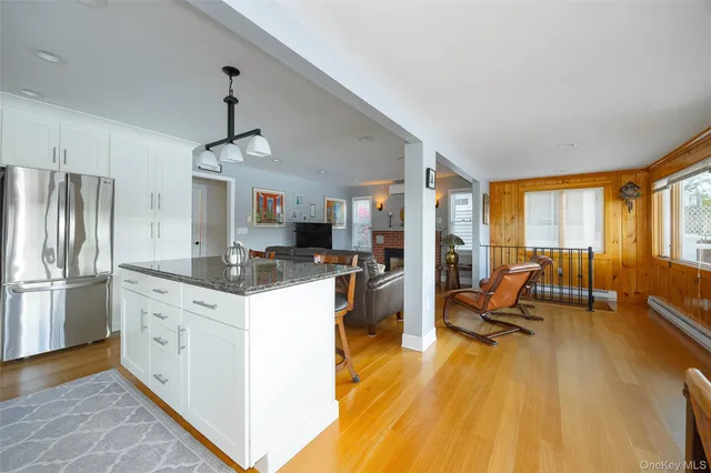 a view of a dining room with furniture large windows and wooden floor