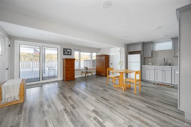 a kitchen with granite countertop white cabinets and stainless steel appliances