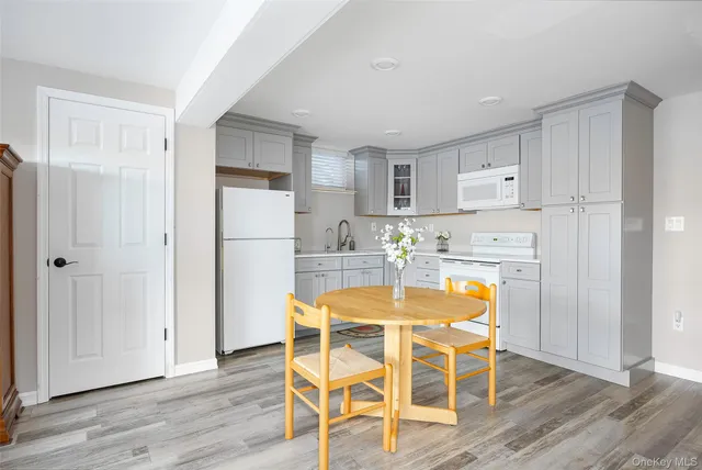 a living room with furniture a table and wooden floor