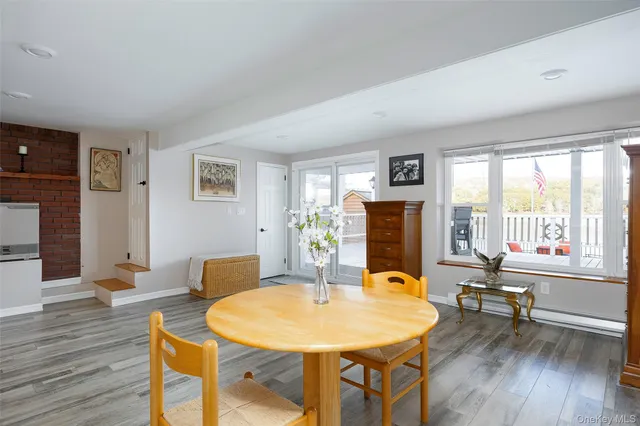 a dining room with furniture and wooden floor