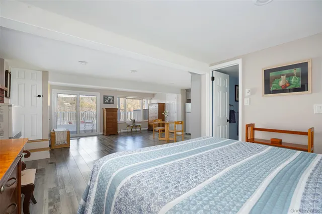 a bedroom with furniture and wooden floor