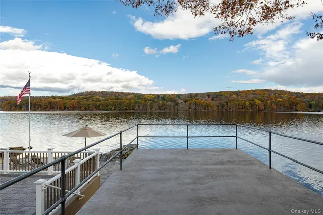 a view of a house with a yard and large trees