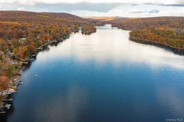 an aerial view of residential house with outdoor space and lake view