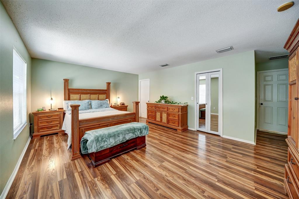 13706 Fareham Road Odessa, FL 33556 - Photo 12 of 21 a bedroom with furniture and wooden floor