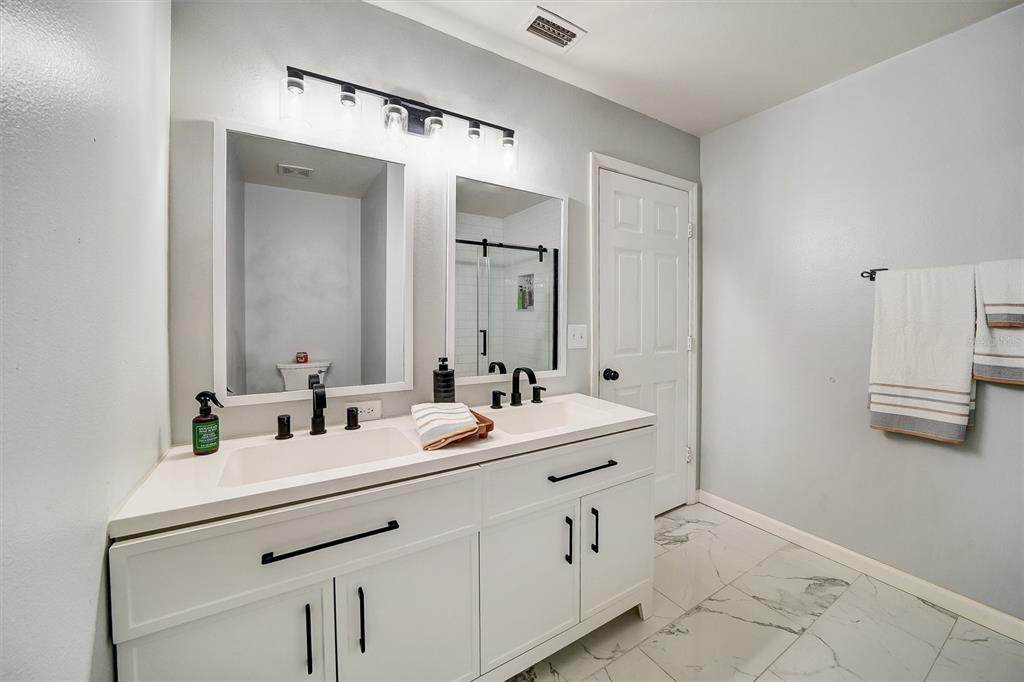 13706 Fareham Road Odessa, FL 33556 - Photo 14 of 21 a bathroom with a double vanity sink mirror and