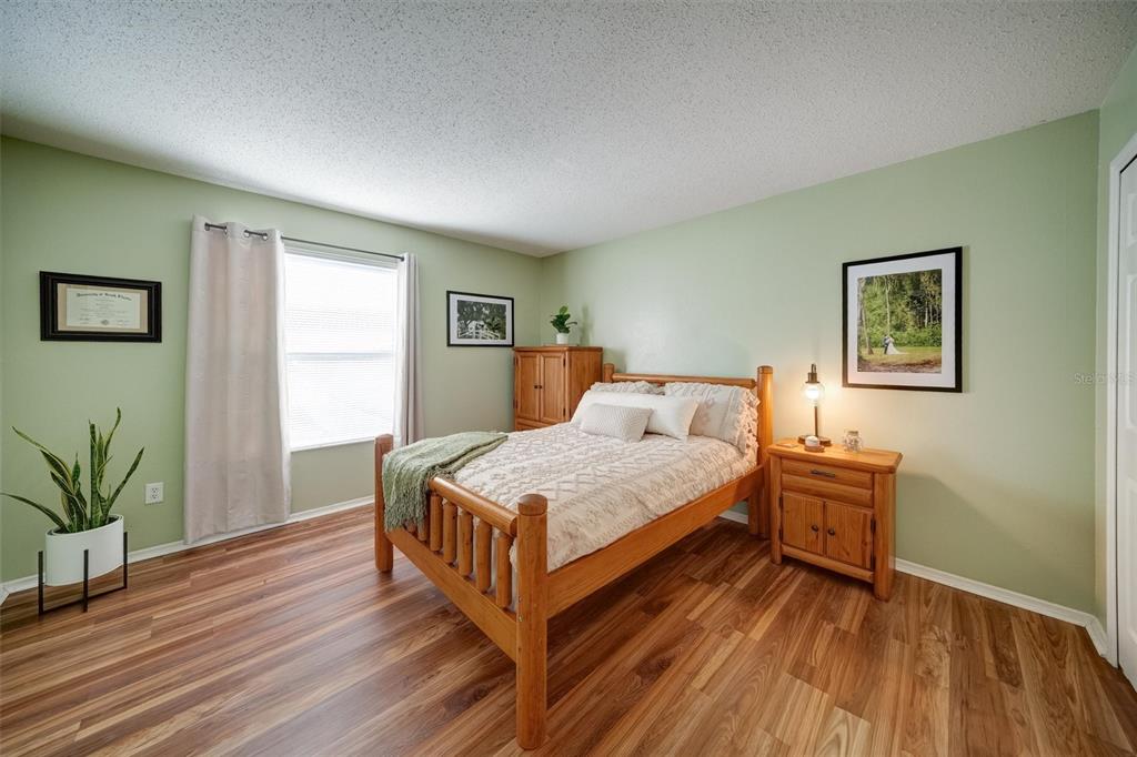 13706 Fareham Road Odessa, FL 33556 - Photo 15 of 21 a bedroom with a bed and a chair