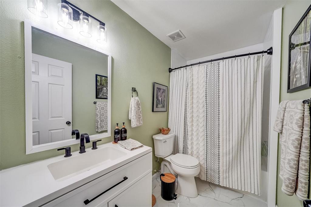 13706 Fareham Road Odessa, FL 33556 - Photo 16 of 21 a bathroom with a sink a toilet and shower