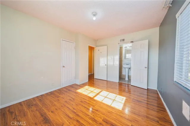 a view of a room with wooden floor and bathroom