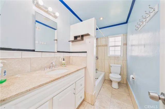 a bathroom with a sink toilet a mirror and shower