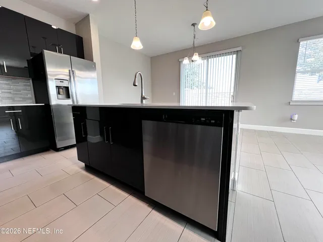 a kitchen with a sink a window and cabinets