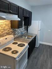 329 East Walnut Lane, Unit 2 Philadelphia, PA 19144 - Photo 3 of 8 a kitchen with a stove and a microwave