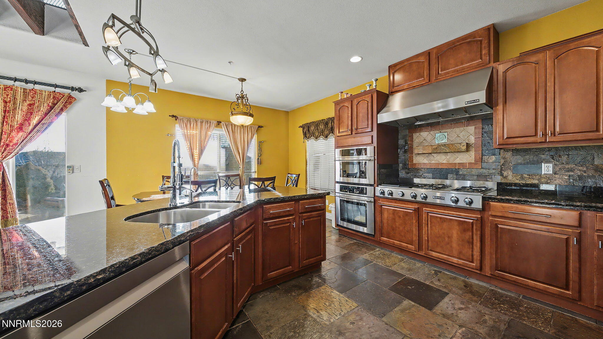3250 Cityview Terrace Sparks, NV 89431 - Photo 5 of 62 a kitchen with stainless steel appliances granite countertop a sink a stove and a wooden cabinets