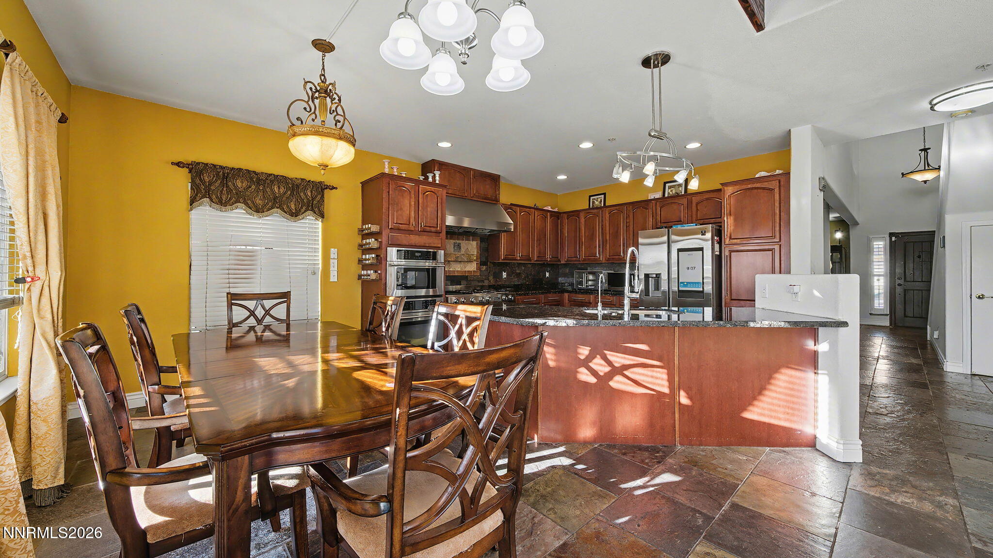 3250 Cityview Terrace Sparks, NV 89431 - Photo 8 of 62 a view of a dining room and livingroom with furniture wooden floor a chandelier