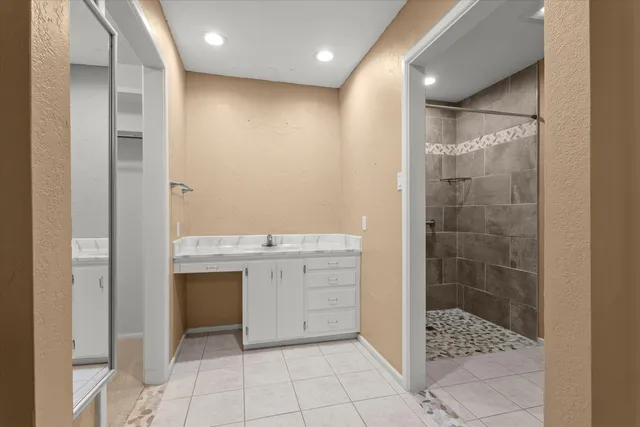 a bathroom with a shower and a sink