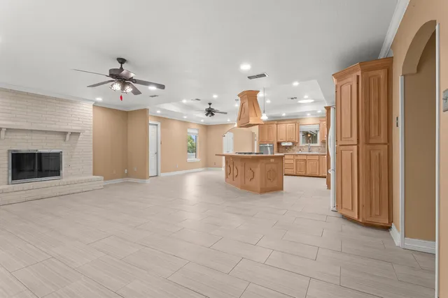 a view of a kitchen with a sink and a refrigerator