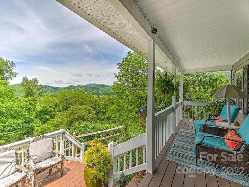 15 Raccoon Point, Unit 7 Canton, NC 28716 - Photo 4 of 39 a view of a balcony with chairs and wooden floor
