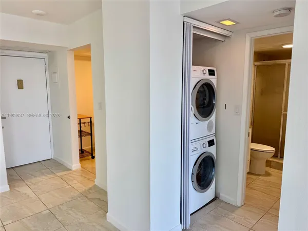 a view of a hallway with washer and dryer