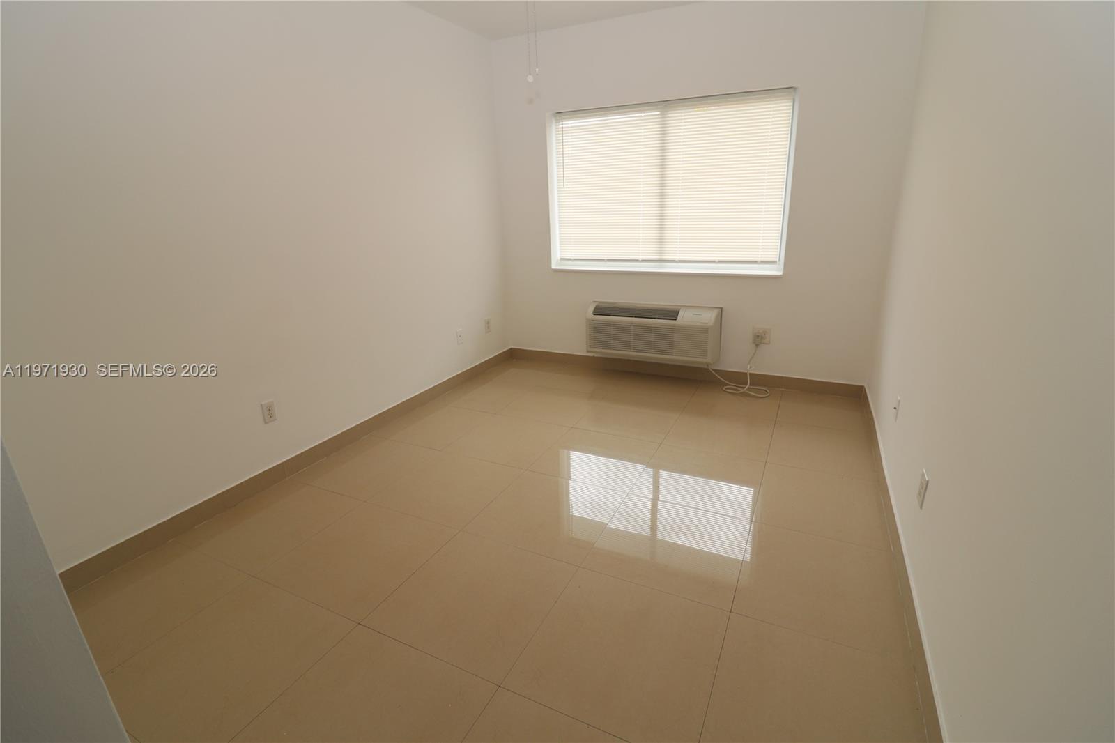 540 74th Street, Unit 10 Miami Beach, FL 33141 - Photo 12 of 27 an empty room with a window