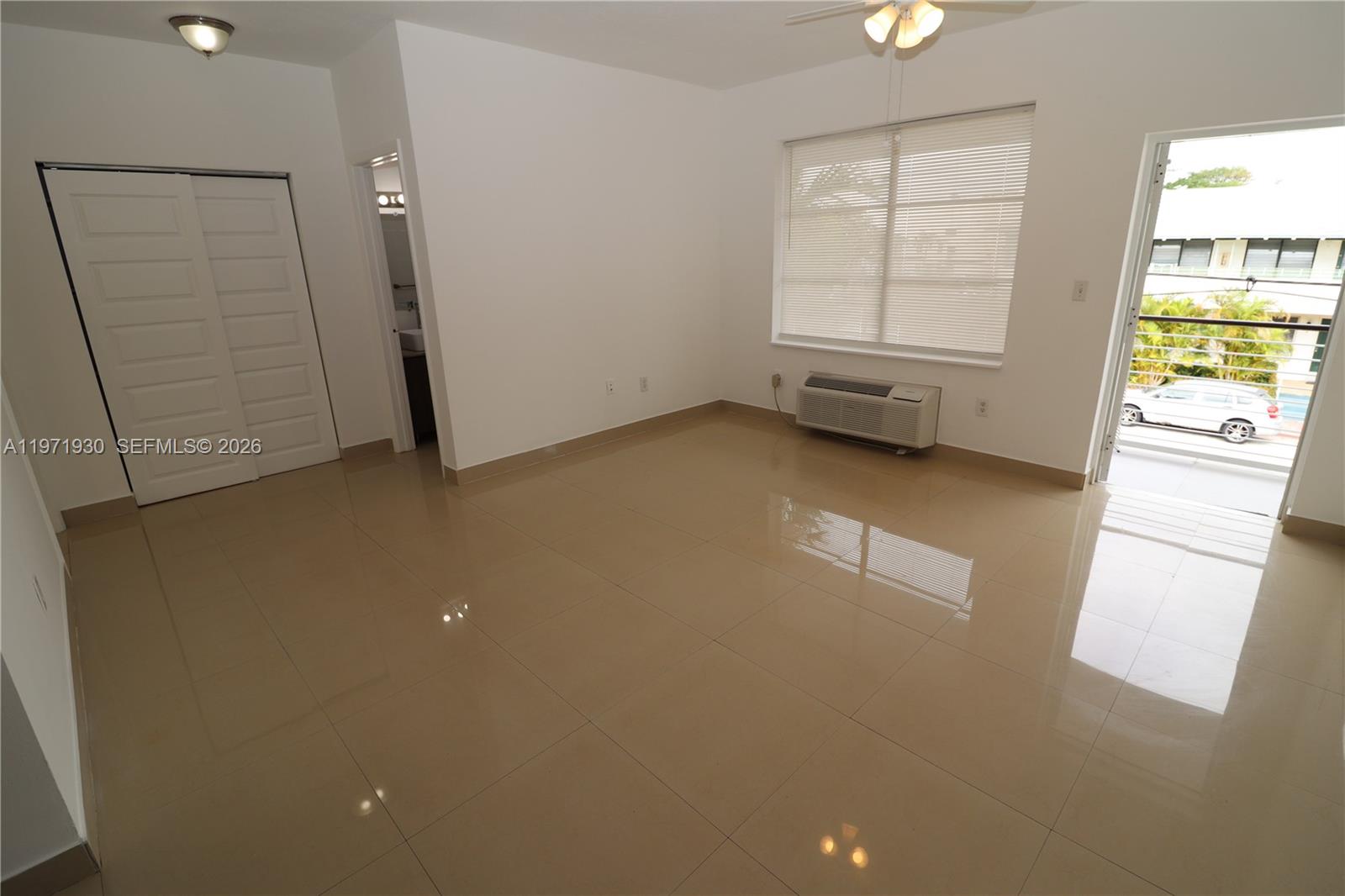 540 74th Street, Unit 10 Miami Beach, FL 33141 - Photo 18 of 27 an empty room with a window