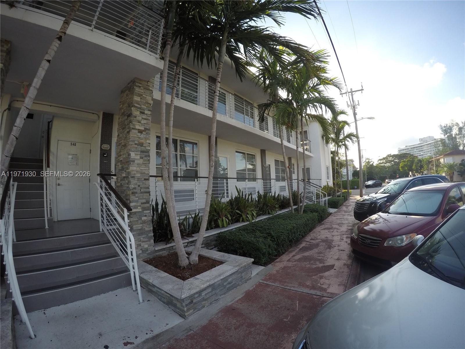 540 74th Street, Unit 10 Miami Beach, FL 33141 - Photo 24 of 27 a view of backyard with outdoor seating and stairs