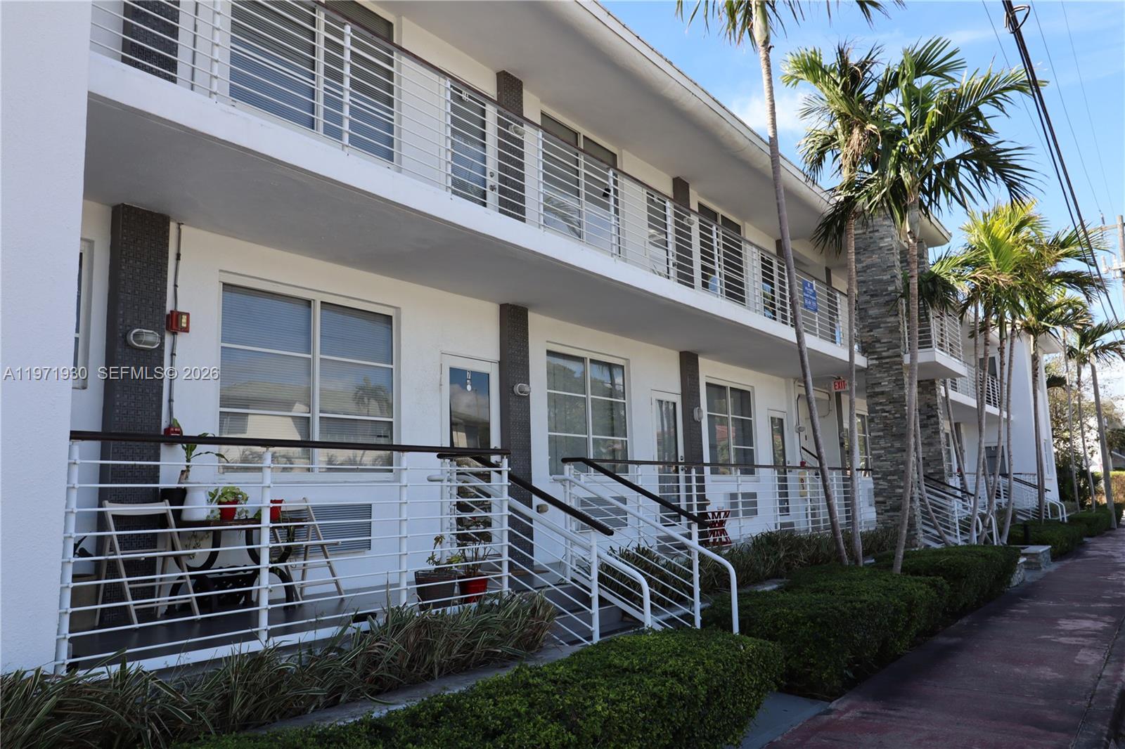 540 74th Street, Unit 10 Miami Beach, FL 33141 - Photo 25 of 27 a view of a house with a yard and potted plants