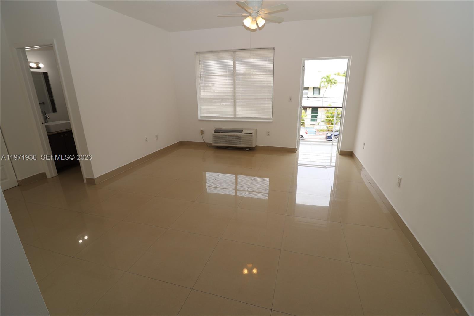 540 74th Street, Unit 10 Miami Beach, FL 33141 - Photo 5 of 27 an empty room with windows