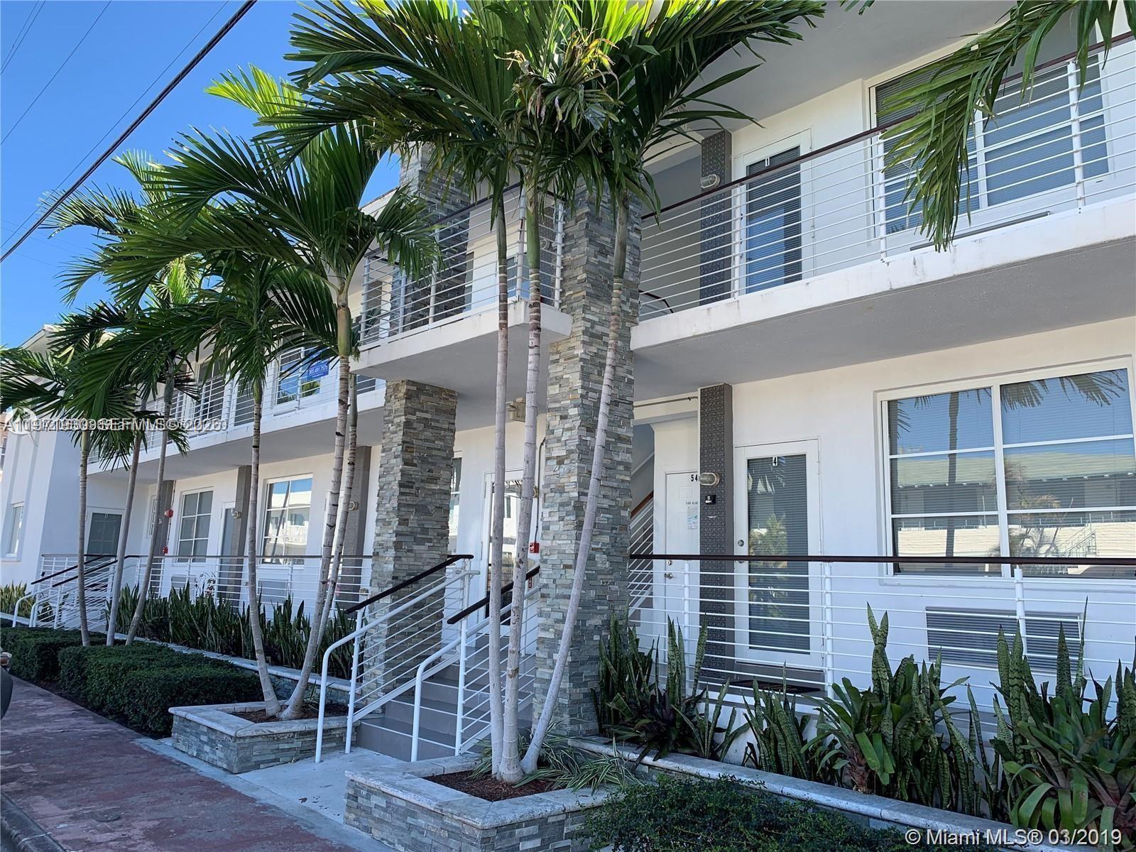 540 74th Street, Unit 10 Miami Beach, FL 33141 - Photo 6 of 27 a couple of palm trees in front of a building
