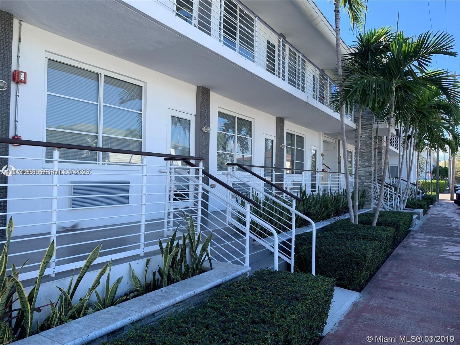 540 74th Street, Unit 10 Miami Beach, FL 33141 - Photo 7 of 27 a view of a house with a yard and potted plants