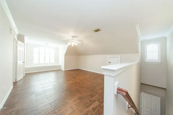 a view of a kitchen with a sink and dishwasher with wooden floor