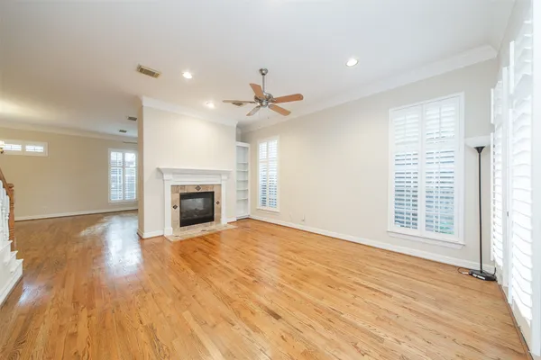 a view of an empty room with a fireplace and a window