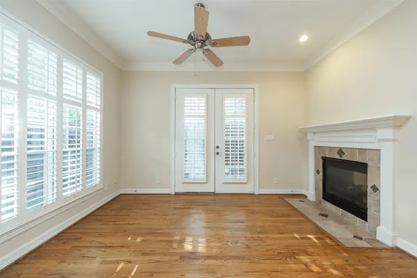 a view of an empty room with a fireplace and a window
