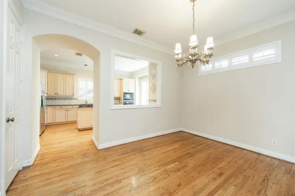 a view of a kitchen with wooden floor and a kitchen