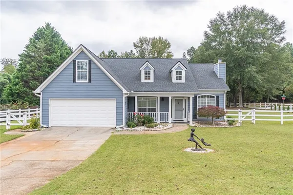 a front view of a house with a yard patio and fire pit