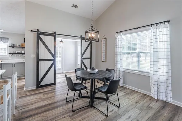 a view of a dining room with furniture window and wooden floor