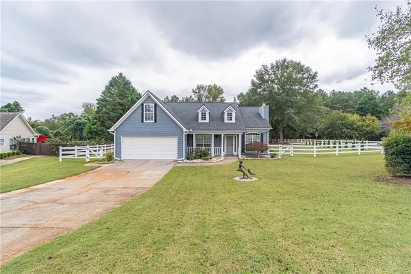 a front view of house with outdoor space and swimming pool