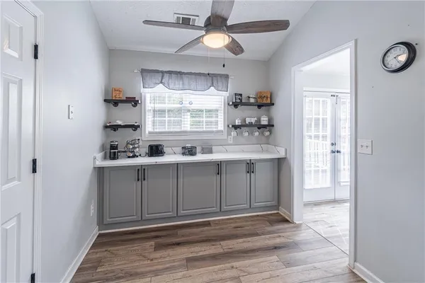 a kitchen with stainless steel appliances granite countertop a stove a sink and a refrigerator with wooden floors