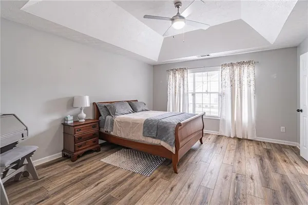 a bedroom with a bed and wooden floor