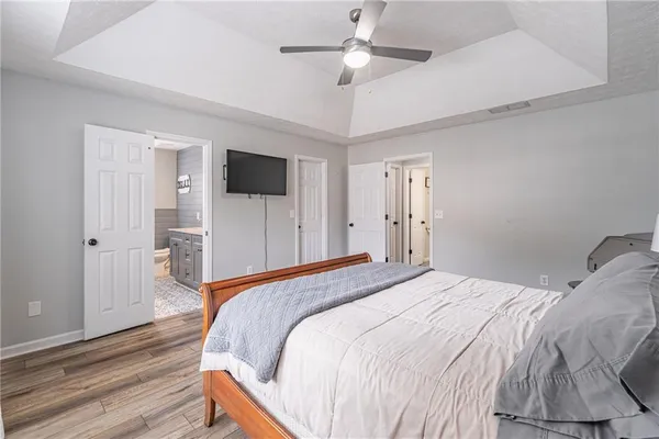 a bedroom with a bed and a chandelier