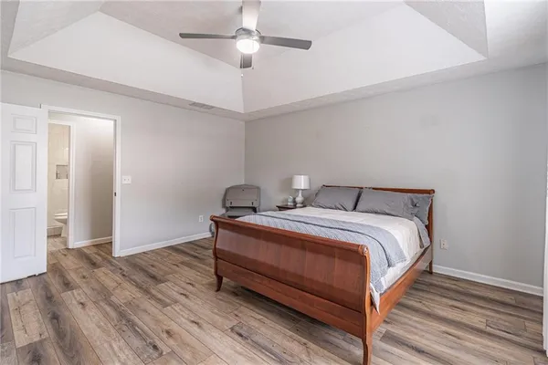 a bedroom with bed and wooden floor