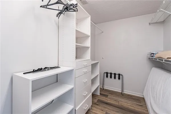 a kitchen with a refrigerator and white cabinets