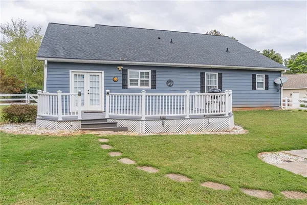 a view of a deck with wooden floor and fence