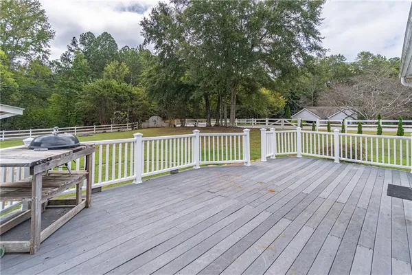 a view of a house with a yard chairs and a table