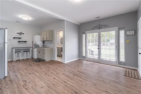 a kitchen with granite countertop a sink stove and refrigerator