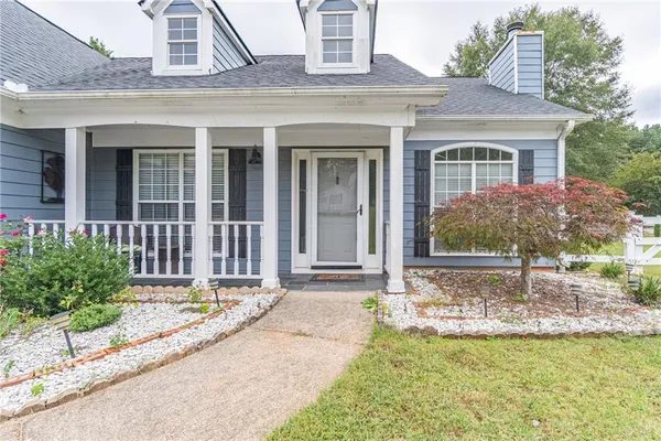 a front view of a house with garden