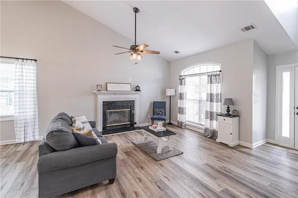 a living room with furniture and a fireplace