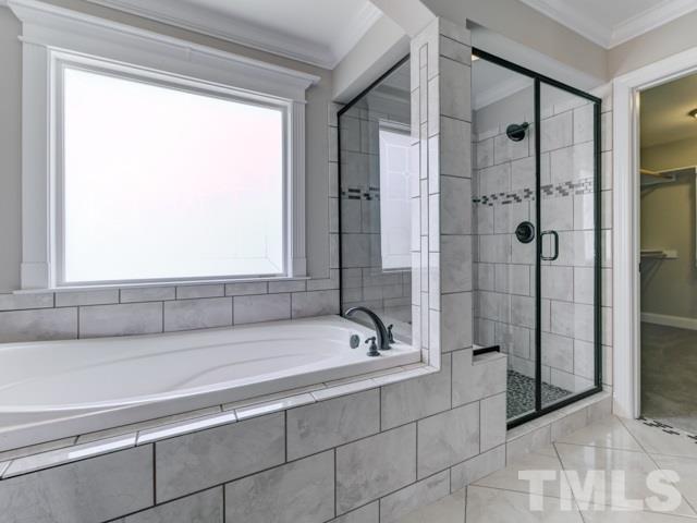 9814 Chris Drive Raleigh, NC 27603 - Photo 14 of 25 a bathroom with a bathtub and a shower