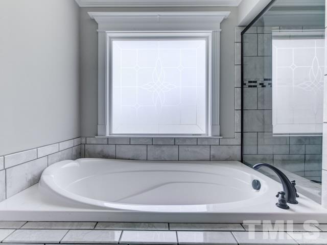 9814 Chris Drive Raleigh, NC 27603 - Photo 16 of 25 a bathroom with a bathtub