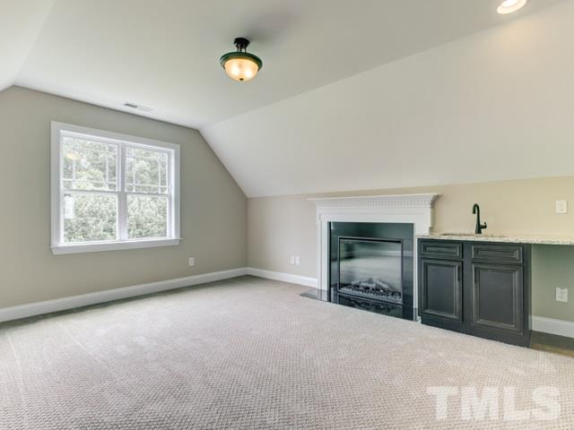 9814 Chris Drive Raleigh, NC 27603 - Photo 18 of 25 an empty room with a fireplace and window