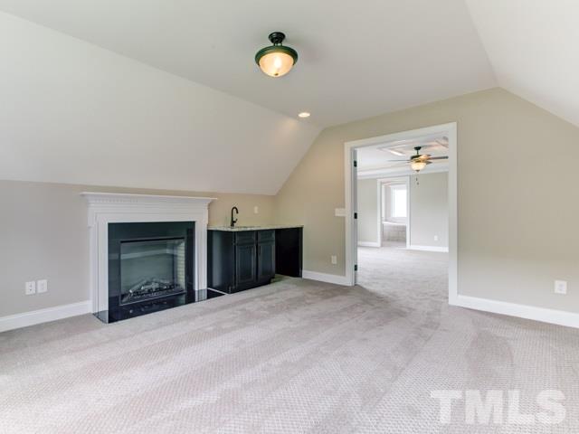 9814 Chris Drive Raleigh, NC 27603 - Photo 19 of 25 an empty room with a fireplace and a window