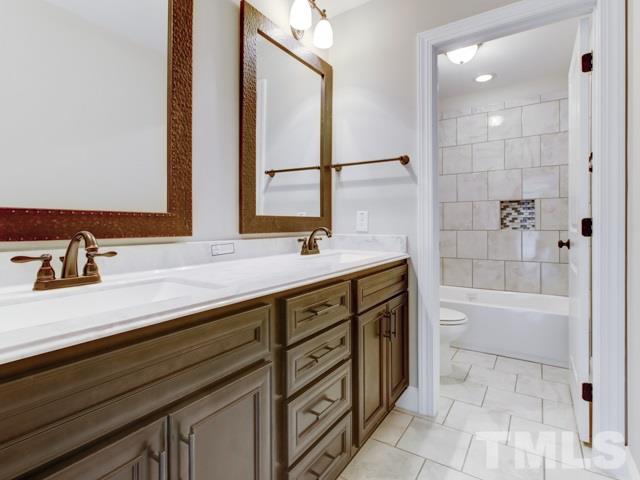 9814 Chris Drive Raleigh, NC 27603 - Photo 20 of 25 a bathroom with a sink double vanity and a bathtub